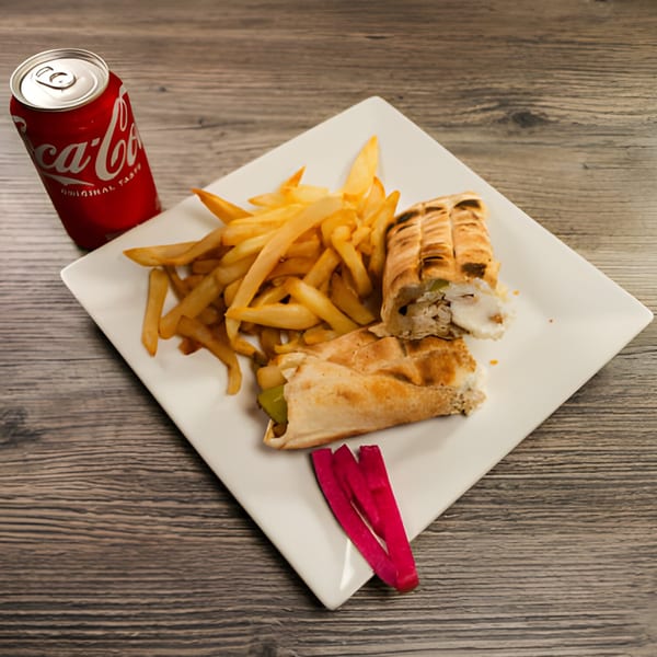 Lebanese chicken shawarma wraps, french fries, pickled turnips, and a Coca-Cola on a white plate.